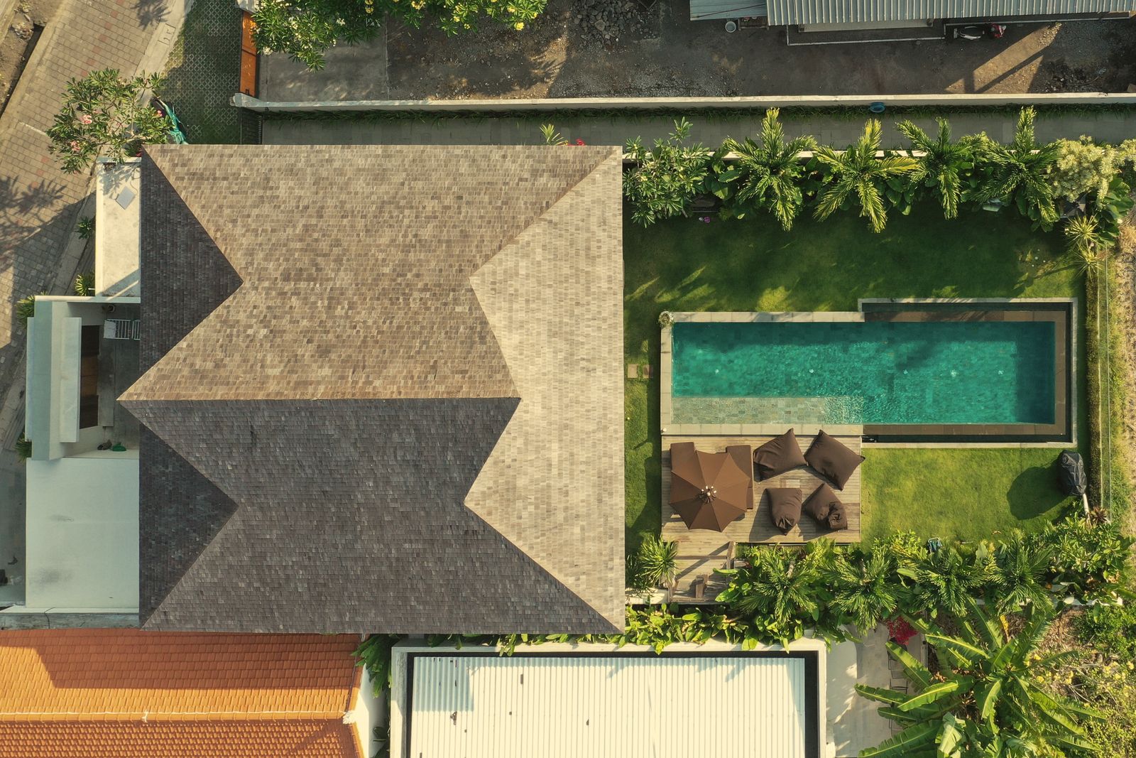 Overhead view of the shingled roof, pool and garden