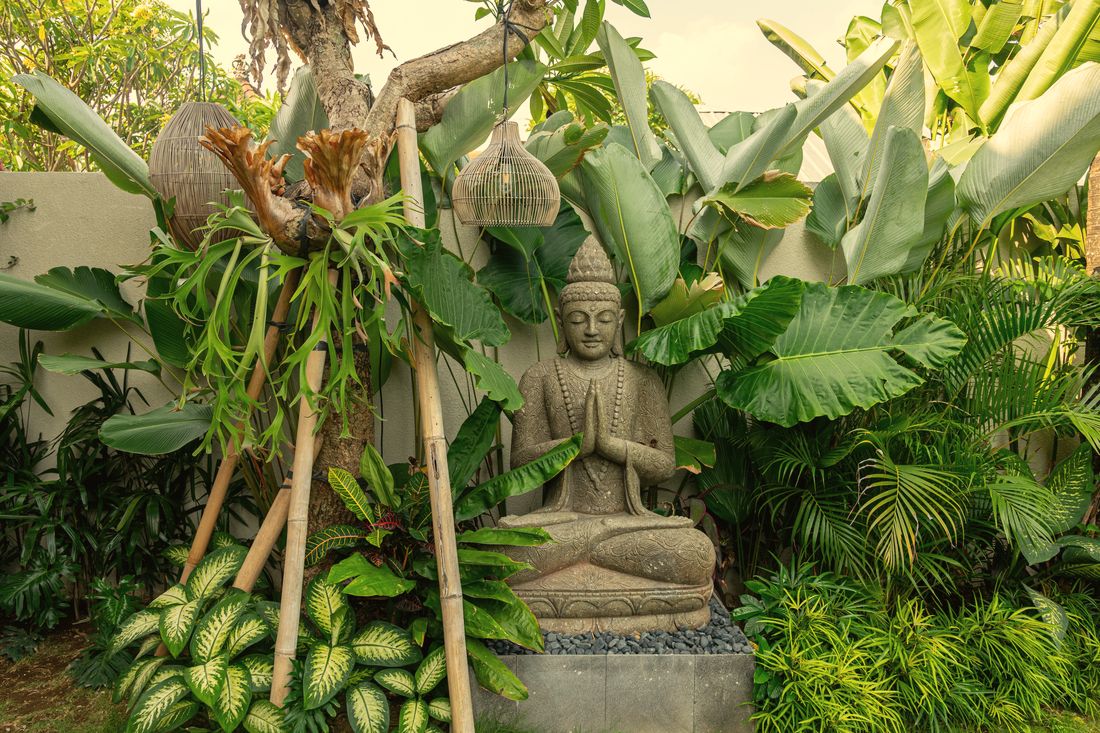 Stone Buddha in the tropical garden