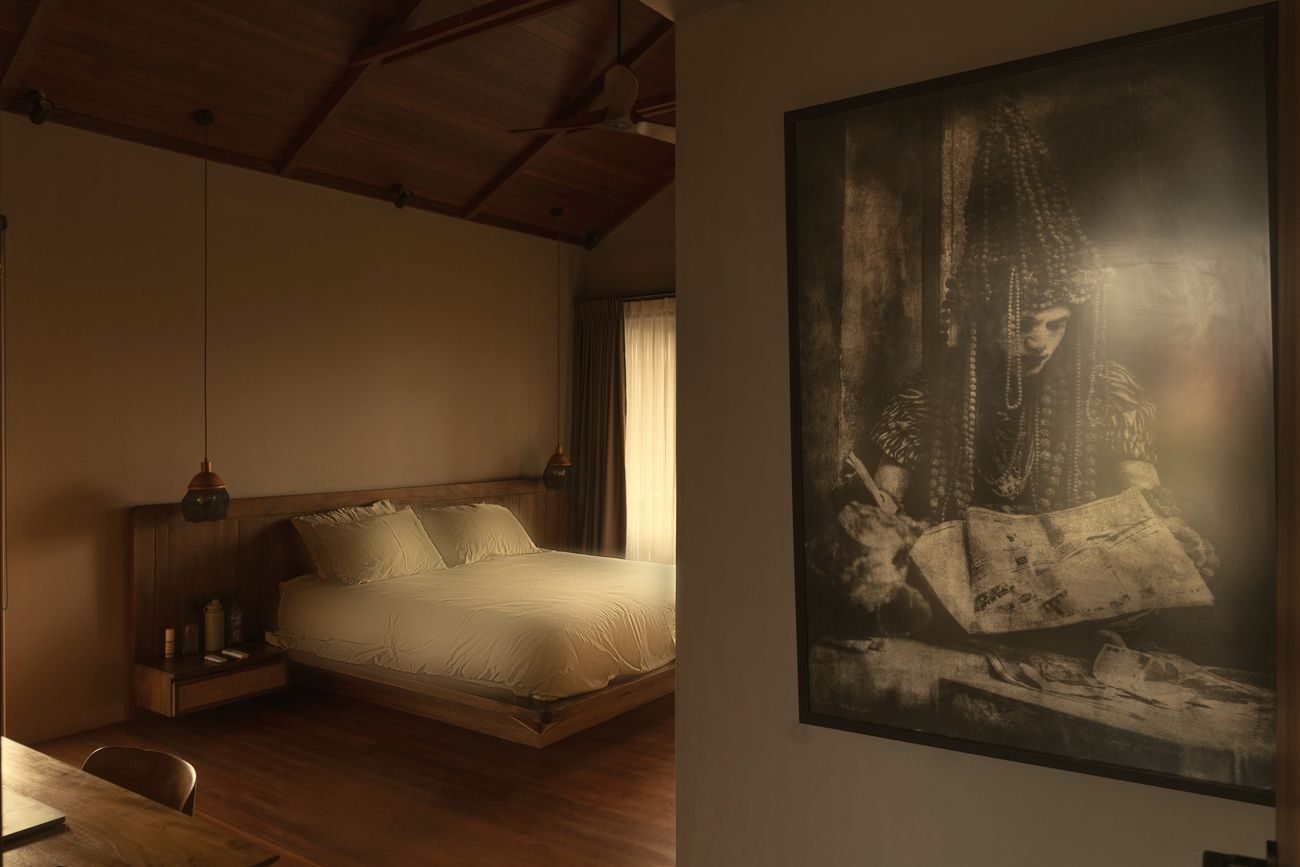 Second bedroom with timber floors and large artwork